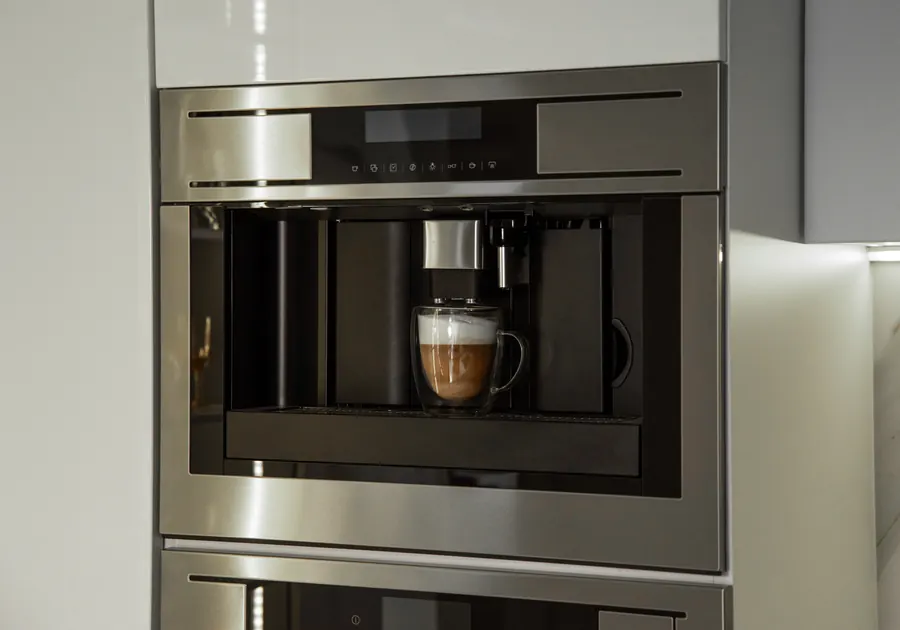 Built-in coffee machine fitted into kitchen cabinetry