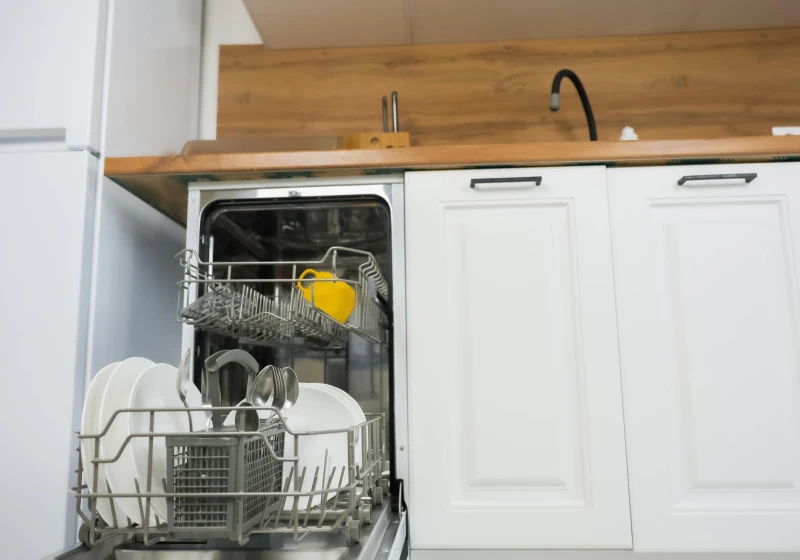Open dishwasher loaded with clean dishes